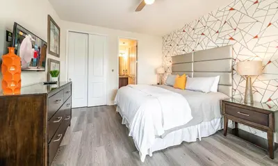 a bedroom with a large white bed and a dresser at Ultimate 5 Star Villa with Private Pool on Encore Resort at Reunion Orlando Villa 4391 in Orlando