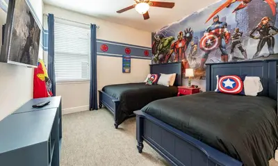 a bedroom with two beds with superheroes on the walls at Ultimate 5 Star Villa with Private Pool on Encore Resort at Reunion Orlando Villa 4391 in Orlando