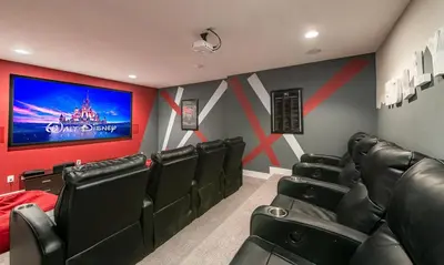 a movie room with black chairs and a flat screen tv at Ultimate 5 Star Villa with Private Pool on Encore Resort at Reunion Orlando Villa 4391 in Orlando