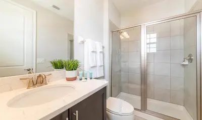 a white bathroom with a sink and a shower at Rent the Perfect 8 Bedroom Villa on Encore Resort at Reunion Orlando Villa 4474 in Orlando