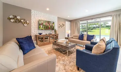 a living room with two couches and a table at Rent the Perfect 8 Bedroom Villa on Encore Resort at Reunion Orlando Villa 4474 in Orlando