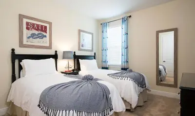 a bedroom with two beds and a mirror at 5 Star Villa on Orlando’s most Exclusive Encore Resort at Reunion Orlando Villa 4355 in Orlando