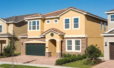 a large house with a garage at 5 Star Villa on Orlando’s most Exclusive Encore Resort at Reunion Orlando Villa 4355 in Orlando