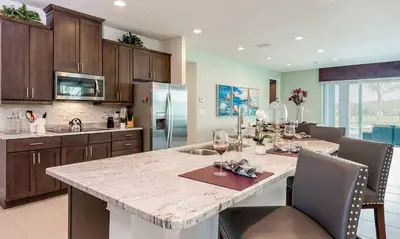 a large kitchen with a large marble counter top at 5 Star Villa on Orlando’s most Exclusive Encore Resort at Reunion Orlando Villa 4377 in Orlando