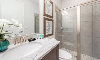 a white bathroom with a sink and a toilet at 5 Star Villa on Orlando’s most Exclusive Encore Resort at Reunion Orlando Villa 4377 in Orlando