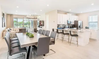 a kitchen and dining room with a table and chairs at 5 Star Villa on Orlando’s most Exclusive Encore Resort at Reunion Orlando Villa 4507 in Orlando