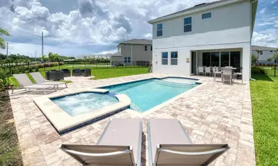 a swimming pool in the backyard of a house at 5 Star Villa on Orlando’s most Exclusive Encore Resort at Reunion Orlando Villa 4507 in Orlando