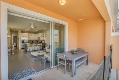 a dining room with a table and a kitchen at Modern Townhome with 3 Bedrooms 5506 in Orlando
