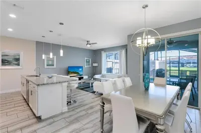 a kitchen and dining room with a table and chairs at Luxury Townhome on Storey Lake Resort Orlando Townhome 5523 in Kissimmee