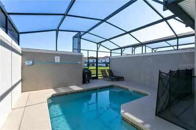 an indoor swimming pool with a glass roof at Luxury Townhome on Storey Lake Resort Orlando Townhome 5523 in Kissimmee