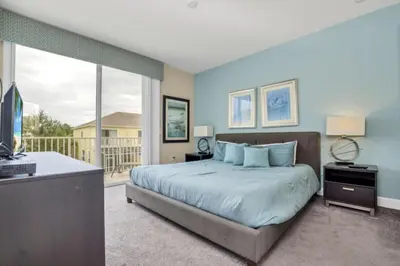 a bedroom with a large bed and a balcony at 3BR Townhome with Stunning Views 5528 in Orlando