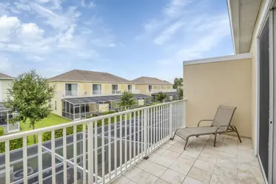 a patio with a chair on a balcony at 3BR Townhome with Stunning Views 5528 in Orlando