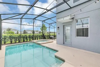 a swimming pool in a house with a patio at You Will Love this 5 Star Villa located on Storey Lake Resort Orlando villa 5492 in Kissimmee