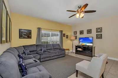 a living room with a couch and a flat screen tv at Luxury 5 Star Villa on Paradise Palms ResortMinutes from Disney World Orlando Townhome 5502 in Kissimmee