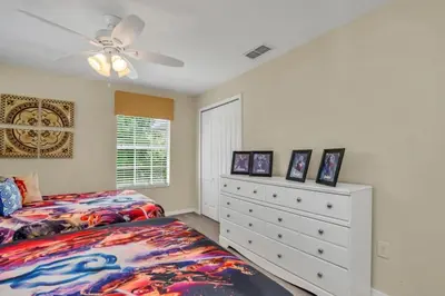 a bedroom with two beds and a dresser at Luxury 5 Star Villa on Paradise Palms ResortMinutes from Disney World Orlando Townhome 5502 in Kissimmee