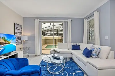 a living room with a white couch and blue chairs at Imagine You and Your Family Renting this 5 Star Villa on Storey Lake Resort Orlando Townhome 5519 in Kissimmee