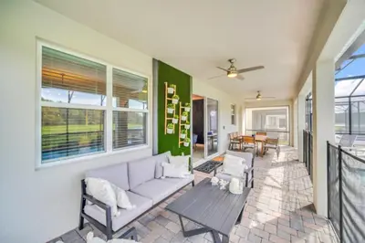 a living room with a couch and a table at Modern 9 Bedroom Oasis for Large Groups 6272 in Kissimmee