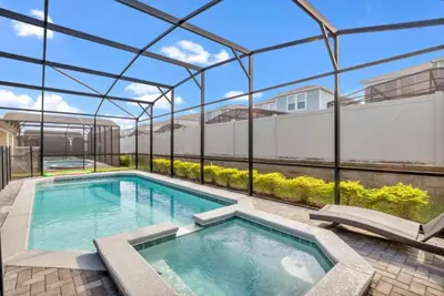 an indoor swimming pool with a glass roof at Elegant Villa for Large Groups 6281 in Kissimmee