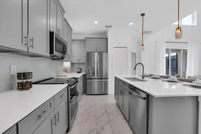 a kitchen with white counters and stainless steel appliances at Ultimate 5 Bedroom Villa Escape 6314 in Kissimmee