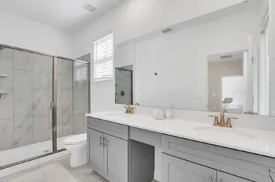 a bathroom with a sink and a toilet and a shower at Ultimate 5 Bedroom Villa Escape 6314 in Kissimmee