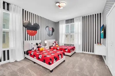 two beds in a bedroom with black and white stripes at Ultimate 5 Bedroom Villa Escape 6314 in Kissimmee