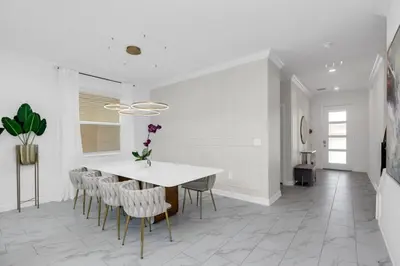 a white dining room with a table and chairs at Ultimate 5 Bedroom Villa Escape 6314 in Kissimmee