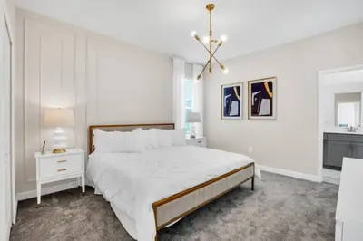 a white bedroom with a large bed and a chandelier at Ultimate 5 Bedroom Villa Escape 6314 in Kissimmee