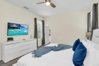 a bedroom with two white beds and a flat screen tv at Escape to a 5 Bedroom Villa in Paradise 6316 in Kissimmee