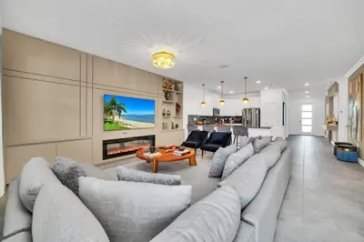 a living room with a large couch and a fireplace at Family-Friendly Villa with 9 Bedrooms 6317 in Kissimmee