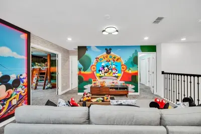 a living room with two couches and a large mural at Family-Friendly Villa with 9 Bedrooms 6317 in Kissimmee