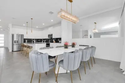 a kitchen and dining room with a table and chairs at Private Oasis: 6 Bedroom Villa Retreat 6327 in Kissimmee