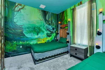 a bedroom with a dinosaur mural on the wall at Elegant Villa Retreat with Private Pool 6328 in Kissimmee