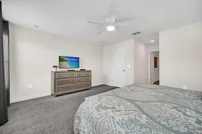 a bedroom with a bed and a tv on a dresser at 6 Bedroom Villa with Tennis Court Gym 6332 in Kissimmee