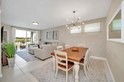a dining room and living room with a table and chairs at Chic Urban Oasis with 3 Bedrooms 6333 in Kissimmee