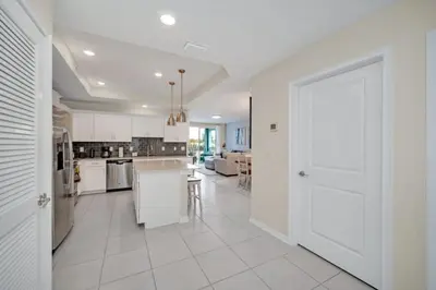a kitchen with white cabinets and a white door at Chic Urban Oasis with 3 Bedrooms 6333 in Kissimmee