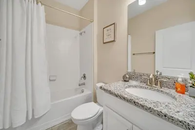 a bathroom with a sink and a toilet and a shower at Modern Villa with Game Room Theater 6334 in Kissimmee