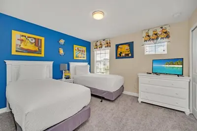 a bedroom with two beds and a flat screen tv at Modern Villa with Game Room Theater 6334 in Kissimmee