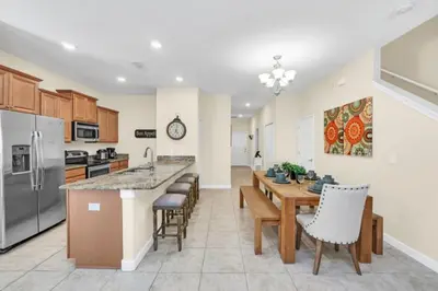 a kitchen and dining room with a table and chairs at Spacious 5 Bedroom Villa for Families 6337 in Kissimmee