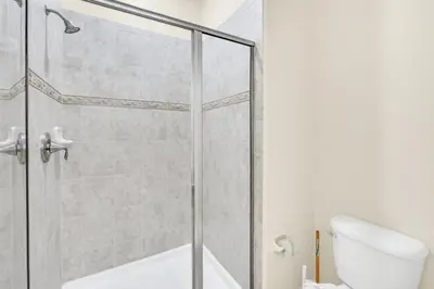a shower stall in a bathroom with a toilet at Spacious 5 Bedroom Villa for Families 6337 in Kissimmee