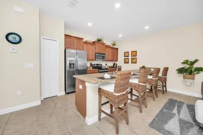 an open kitchen with a table and chairs at Tranquil Villa Retreat with Mountain Views 6338 in Kissimmee