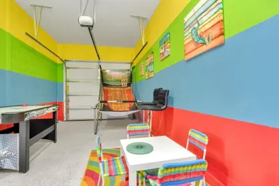 a brightly colored room with a table and chairs at Cozy 4BR Cottage with Fireplace 6379 in Kissimmee