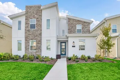 a large white house with a lawn at Spacious Villa Retreat with 9 Bedrooms 6381 in Kissimmee