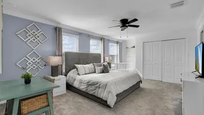 a bedroom with a bed and a ceiling fan at Rent the Perfect 8 Bedroom Villa on Storey Lake Resort Orlando Villa 6293 in Kissimmee