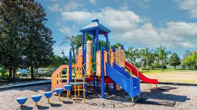 a playground with a slide in a park at Beautiful House with first class amenities on Paradise Palms Resort Orlando House 6298 in Kissimmee