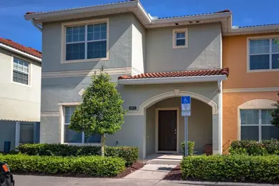 a house with a parking sign in front of it at Rent this Luxury 5 Star Townhome on Paradise Palms Resort Orlando Townhome 6299 in Kissimmee