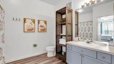 a bathroom with a sink and a toilet and a mirror at Orlando Condo 6420: Family-Friendly Resort Near Disney in Kissimmee