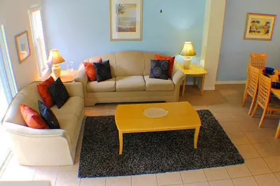a living room with a couch and a coffee table at 5-Star Orlando Townhome 6423 - Resort Amenities Near Disney in Kissimmee