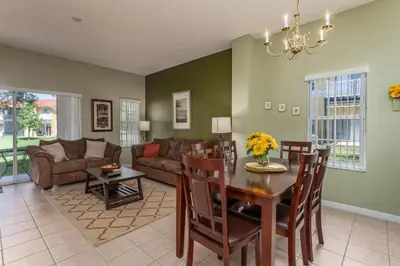 a living room with a table and a couch at Orlando 6424 Townhome: Family Fun Close to Disney in Kissimmee