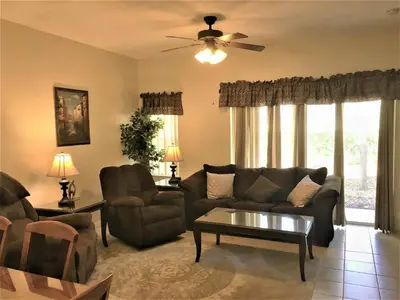 a living room with a couch and a table at Luxury Orlando Townhome 6425 - Emerald Island Resort Stay in Kissimmee