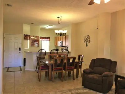 a dining room and kitchen with a table and chairs at Luxury Orlando Townhome 6425 - Emerald Island Resort Stay in Kissimmee
